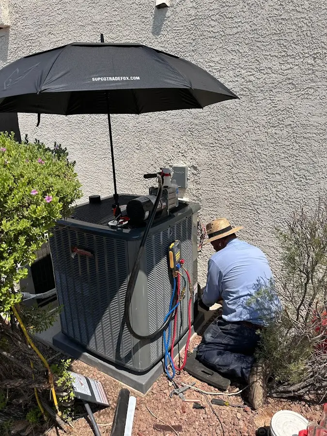 HVAC technician performing outdoor AC maintenance in Olmsted Falls
