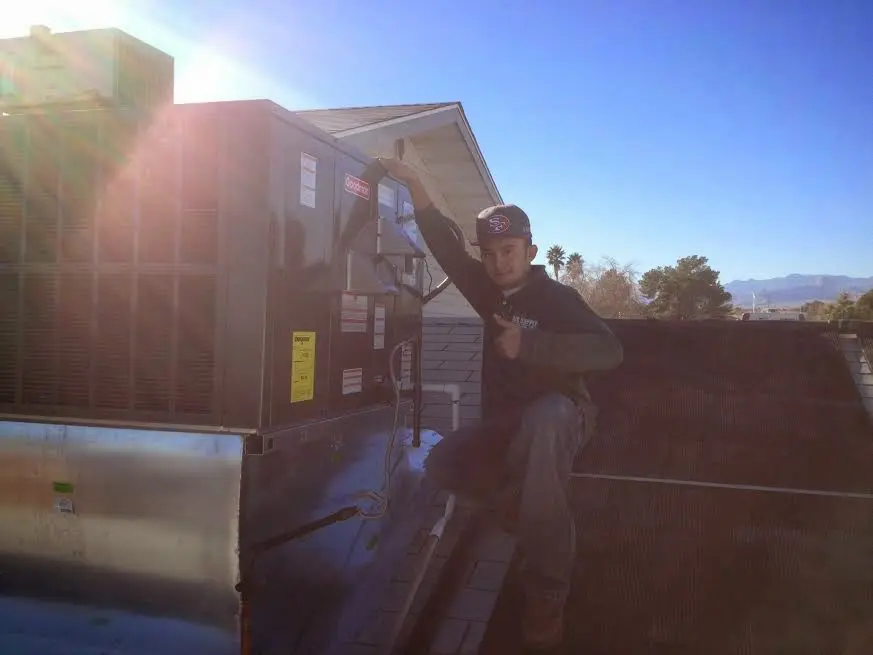 HVAC technician performing Boiler Repair on a rooftop unit in Olmsted Falls